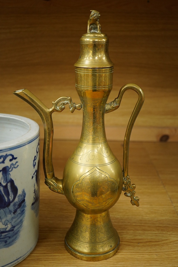 A Chinese cylindrical blue and white brush pot and a brass ewer, largest 39cm high. Condition - fair